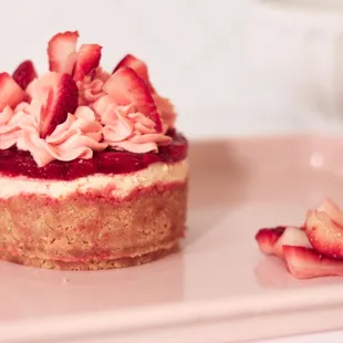 a strawberry cheesecake on a white plate