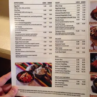 a hand holding a menu