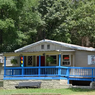 a small house with a blue porch