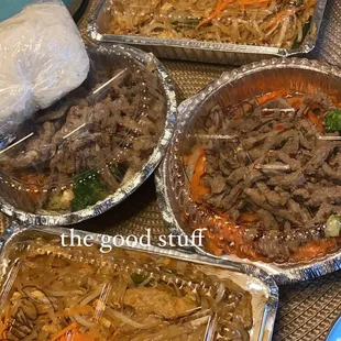 two orders of pud thai with pork, one medium and one mild. two orders of garlic stir fry with beef, one medium and one mild.