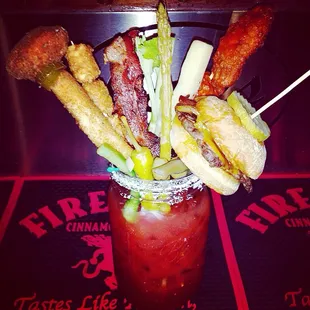 32 ounces of a crazy Bloody Mary with chicken wings, a jalapeño popper, tator tots, a cheeseburger, veggies and cheesesticks!