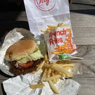Classic burger with everything, crispy fries, and a lollipop