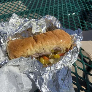 a sandwich wrapped in aluminum foil