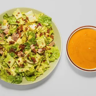a plate of salad and a bowl of soup