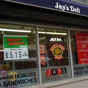 a storefront window with a neon sign