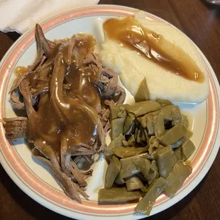 Roast beef, mashed potatoes, green beans with gravy.