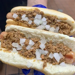 two chili dogs with onions