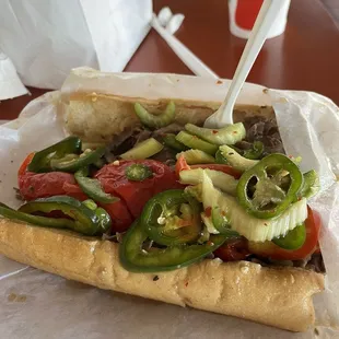 Italian beef w/ hot and sweet peppers half dipped.