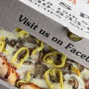 Small pizza with mushrooms, banana peppers, and extra cheese.