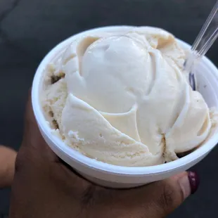 a person holding a bowl of ice cream