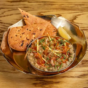 HALEEM

slow cooked goat stew with lentils, taftan bread. (inspired by an Arabian dish harees dating back to 10th century- from Hydrabad