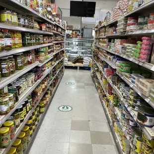 a grocery aisle with canned food