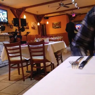 One side of the restaurant has a small dance floor with lights.  A live jazz pianist comes in at night.