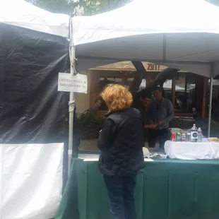 a woman standing under a tent