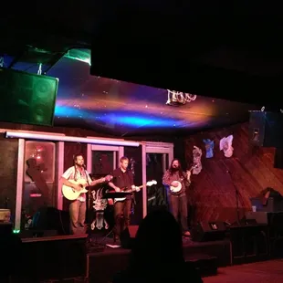 a band playing on stage at night