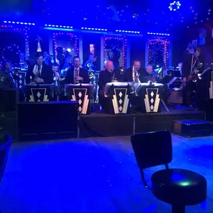 a band playing on stage at night