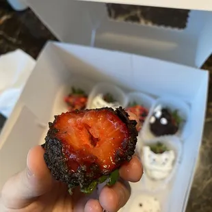 a hand holding a piece of food