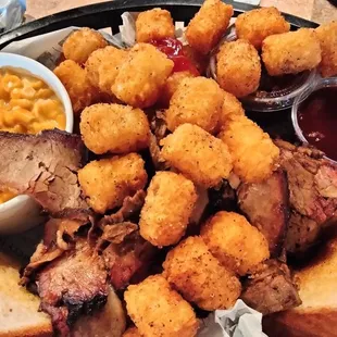 Two meat plate with cheesy corn and tots