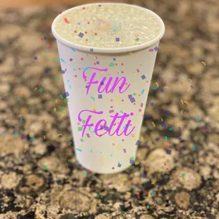 a paper cup with a sprinkle on it