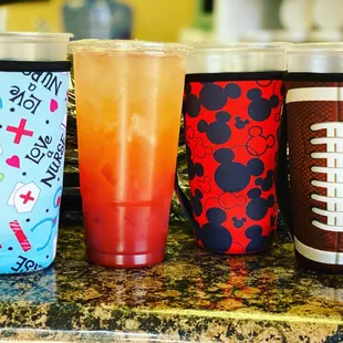 a variety of sports themed cups