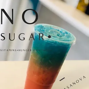 a blue and red drink in a plastic cup