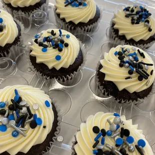 cupcakes with white frosting and blue sprinkles