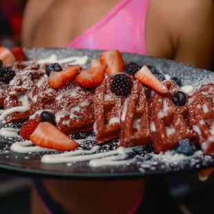 a woman holding a plate of food
