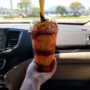 a hand holding a cup of ice cream