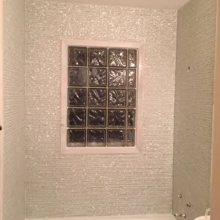 a bathtub and window in a bathroom