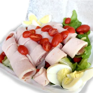 Cobb Salad. Thin sliced turkey, bacon, hard-boiled egg, greens, tomato, and blue cheese dressing.