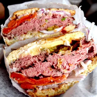 Singing Italian-Overstuffed Sandwich. Roast beef, melted Muenster cheese, roasted red pepper, giardiniera, red onion served on onion roll.