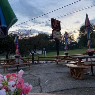a picnic area with tables and umbrellas
