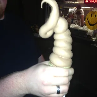 a man holding a spiral ice cream cone