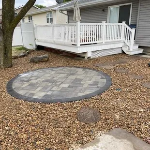 Circular paver patio within rock bed in Crete, NE.
