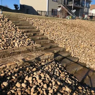 Paver stairway leading through rock garden in Lincoln, NE.