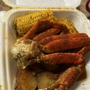 crab legs, corn and potatoes