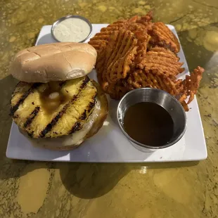 Half pound burger with pepper jack cheese, grilled pineapple, tropical rum glaze and sweet potato fries
