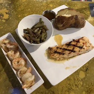 Grilled salmon, shrimp, green beans, baked potato