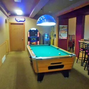 a pool table and arcade machines