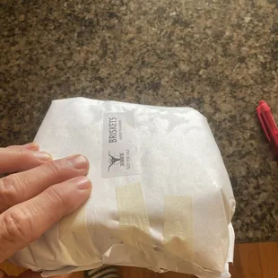 a person holding a bag of food