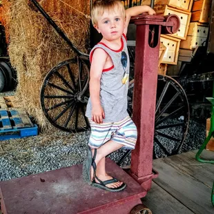 a young boy standing on a wagon