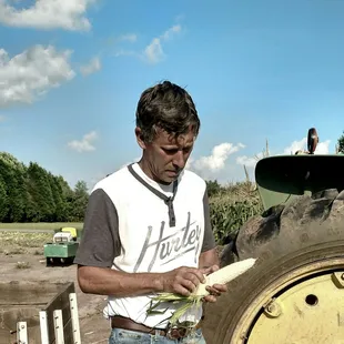 a man standing next to a tractor