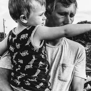 a black and white photo of a man holding a child