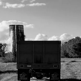 a black and white photo of a dump truck