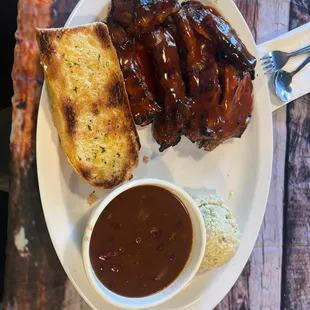 Todays special; ribs and chicken with 2 sides baked beans and potato salad and it comes with garlic bread