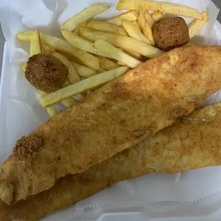a fish and chips meal in a styrofoam container