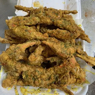 fried crab legs in a styrofoam container