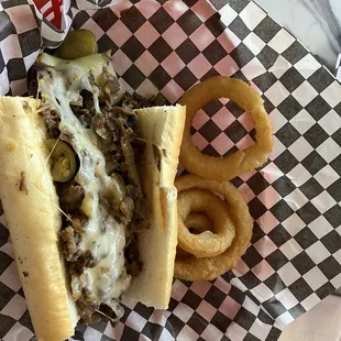 Half cheesesteak and half onion rings, split with Hubbs