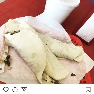 a burrito on a red plate