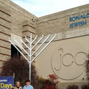 My grandson and I posing for a photo under the Hanukkah Menorah on the 1st Night of Chanukah 2022.